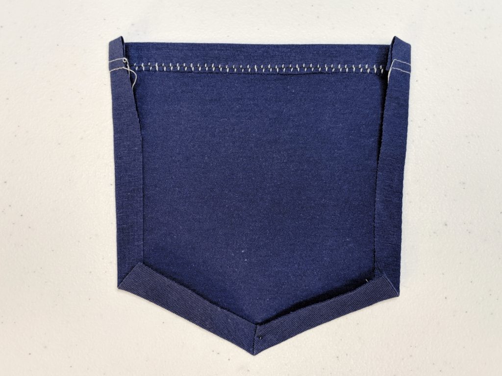 remaining sides of pocket pressed in one half an inch