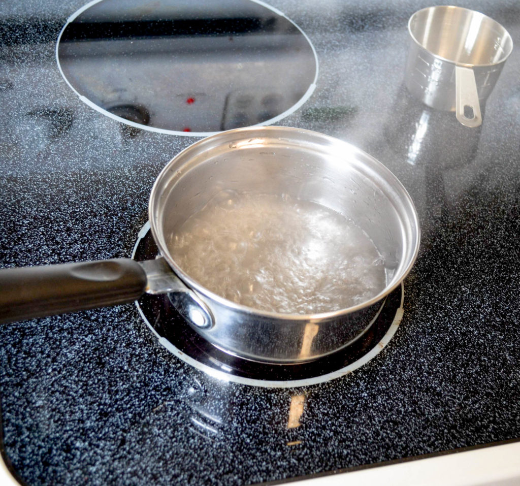 boiling water in a pot on the stove.