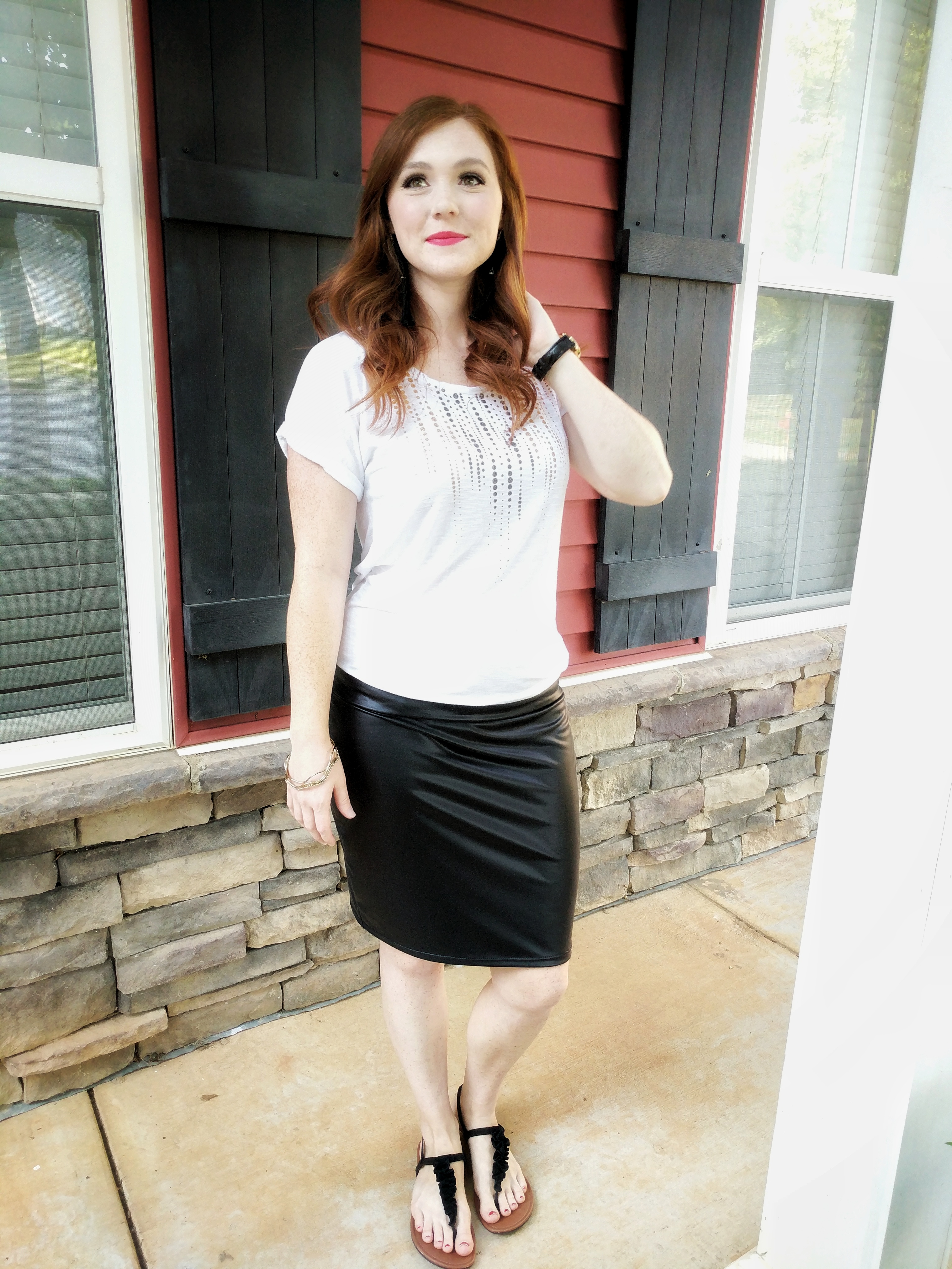Girl modeling a handmade faux leather pencil skirt paired with a white shirt.