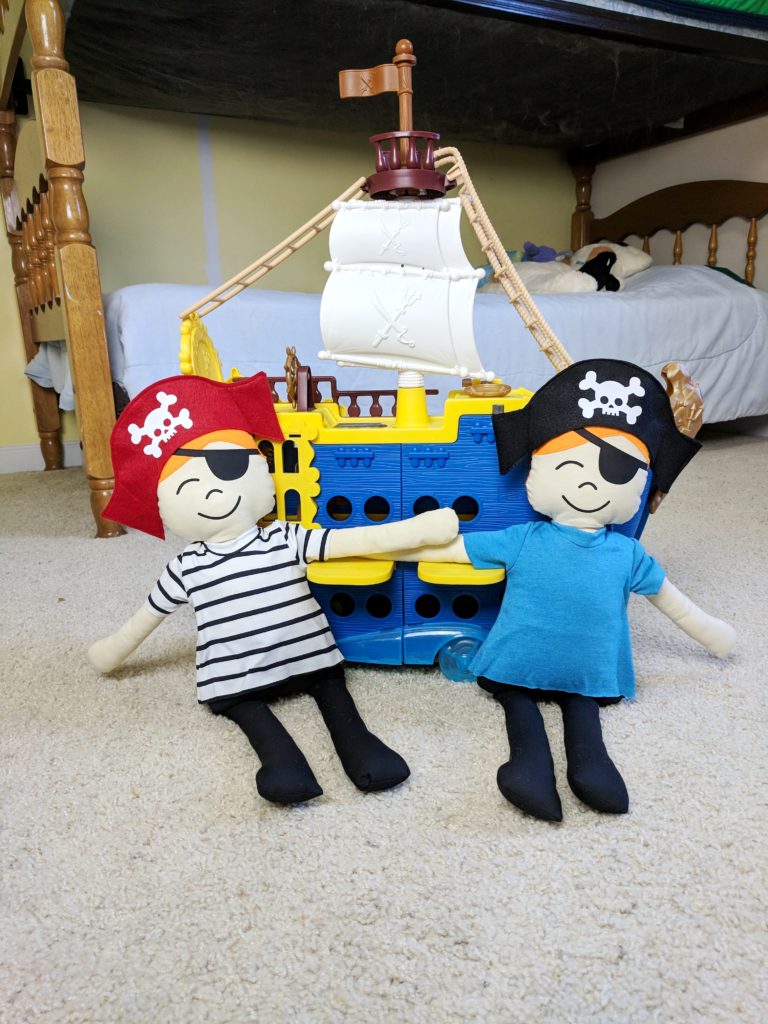 stuffed pirates with a pirate ship