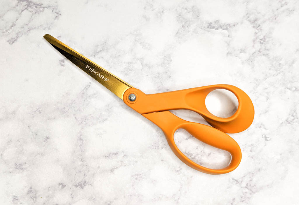Orange handle sewing scissors.
