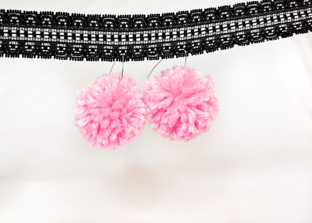 Earrings version one. Made with drop earring hooks and pink pom poms.