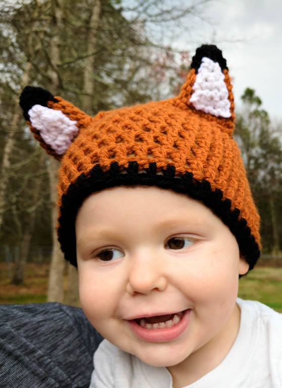 Toddler wearing a crochet fox hat