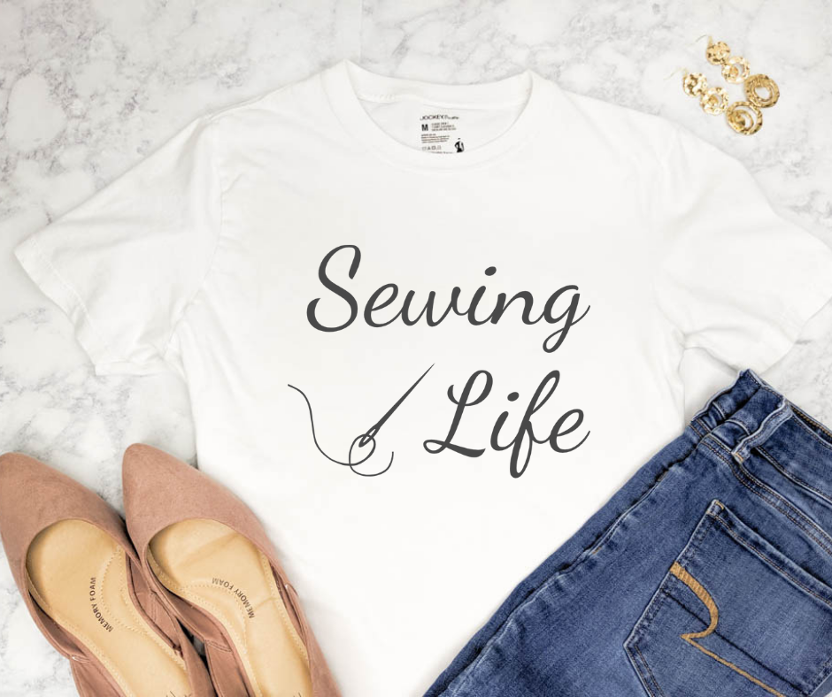 outfit flat lay with blue jeans, pink shoes and a white t shirt with text "sewing life" and a graphic of a sewing needle with thread through it.