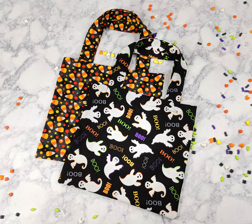Two small tote bags made with Halloween themed fabric.