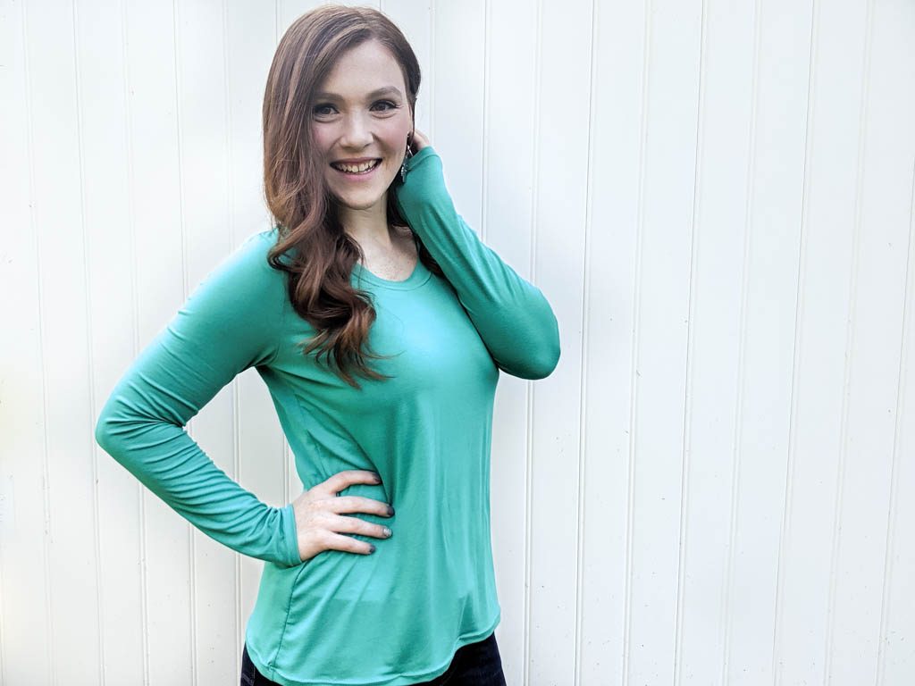 Teal long sleeve layering t shirt modeled by a woman.