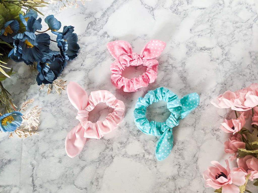three scrunchies in pink and blue.