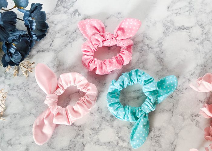 three scrunchies with a bow in a circle.