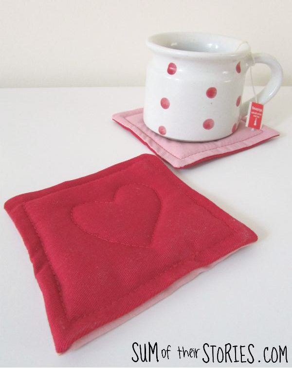 Two valentine coasters. One has a mug on it, the other is close up so you can see the detail of a heart stitched on top.
