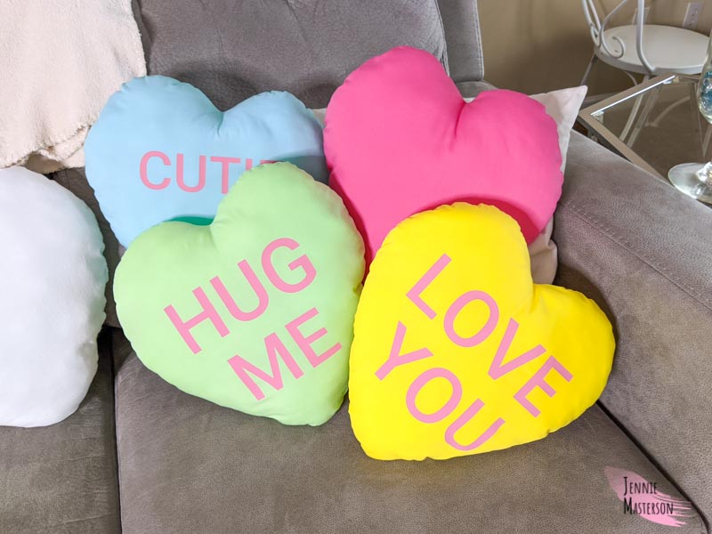 Heart pillows of various colors. Created with text to look like conversation hearts.