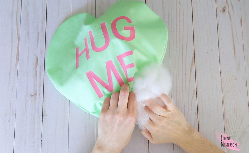 Stuffing the heart pillow with poly fil.