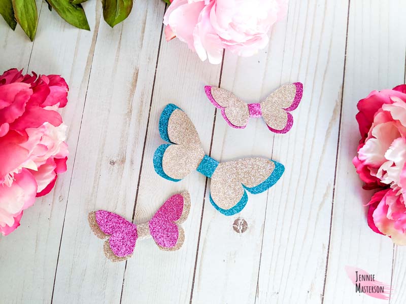 Three butterfly bows in various colors.