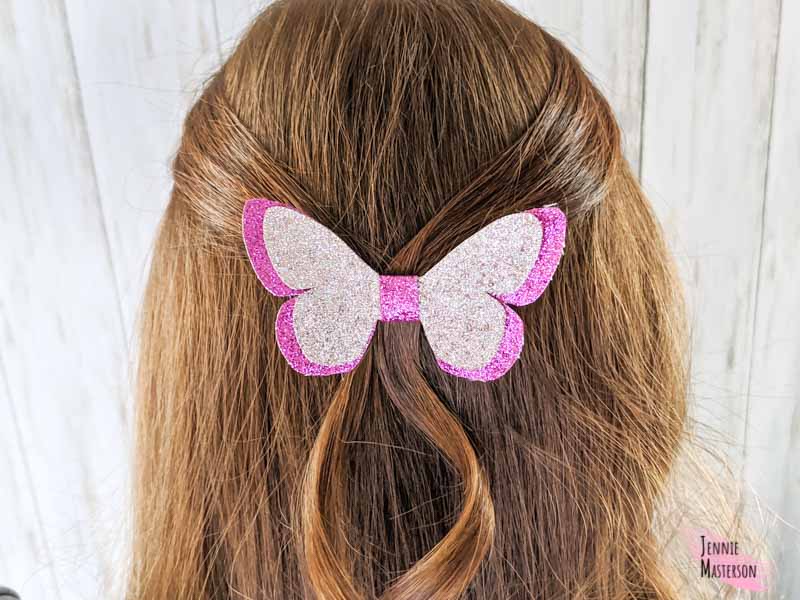 Butterfly bow made from glitter canvas worn in hair.