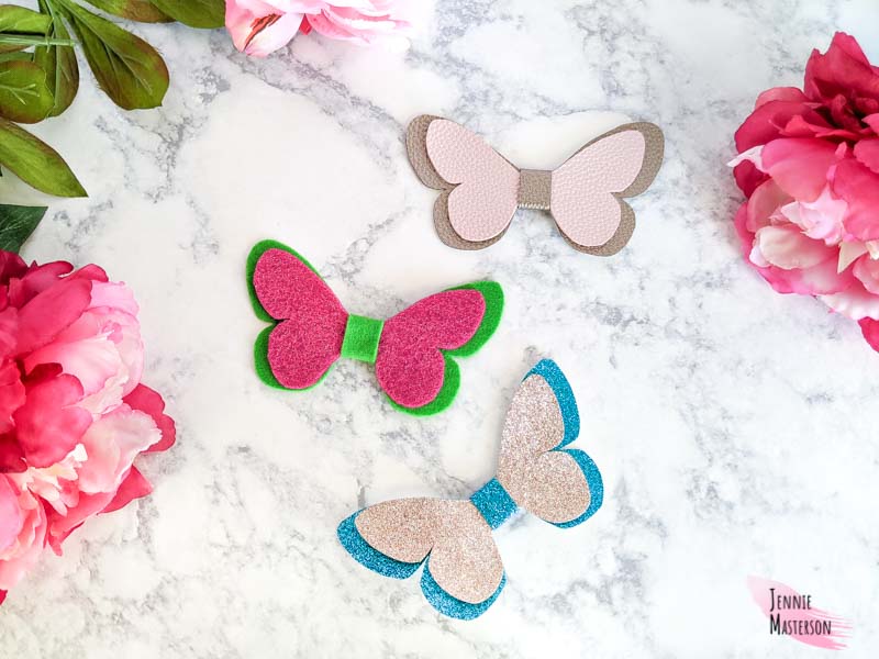 Three butterfly bows made in faux leather, felt, and glitter canvas.