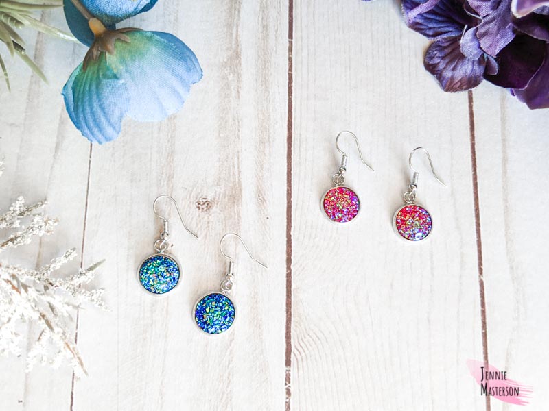 two sets of faux druzy stone earrings. One is blue, the other is pink.