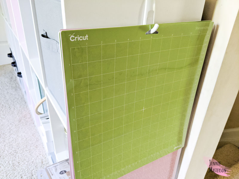 Cricut mats on a command hook. Hanging on the side of my cube shelving.