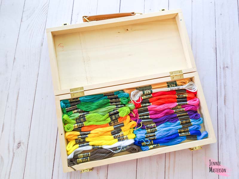 My embroidery floss stash organized in a wooden box with hinges.