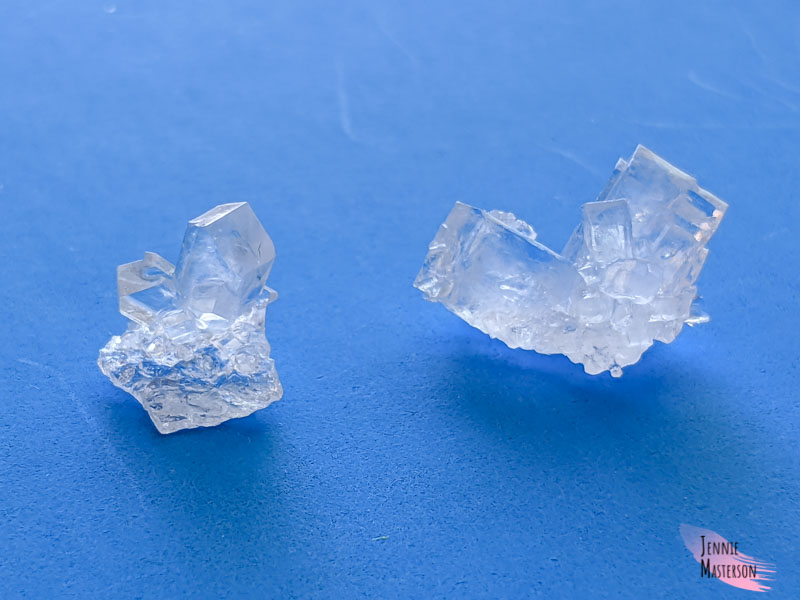 two sugar crystals side by side.