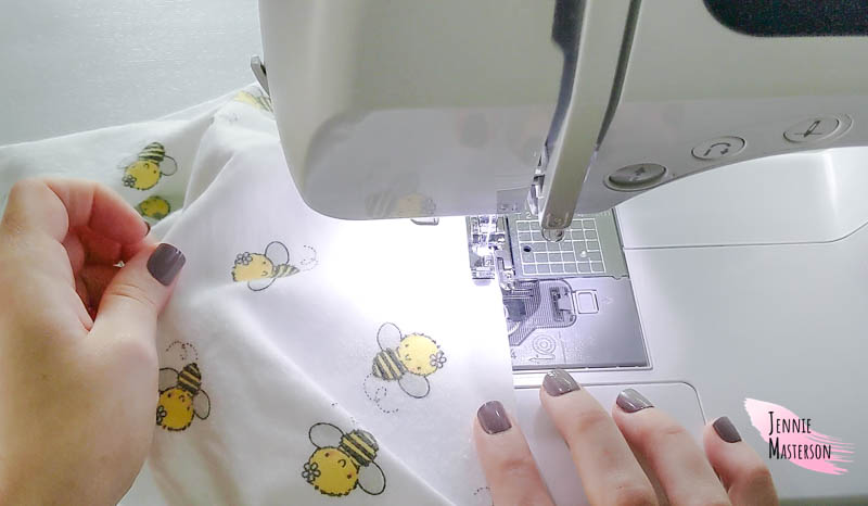 Sewing the receiving blanket edges.