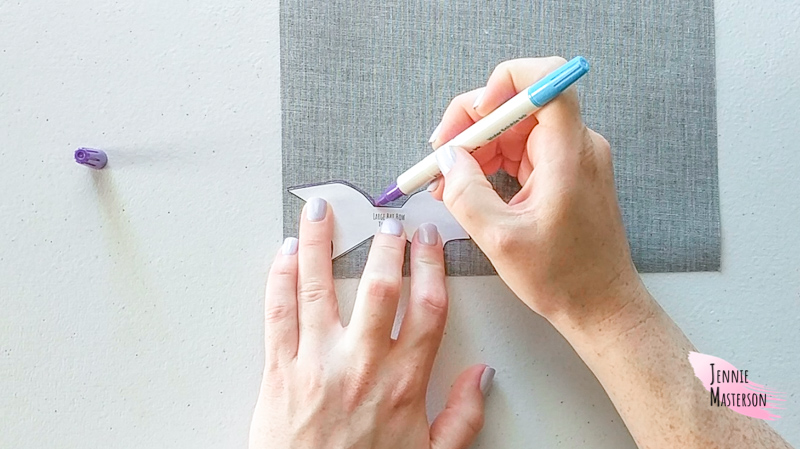 Tracing the pattern onto glitter canvas using disappearing ink.