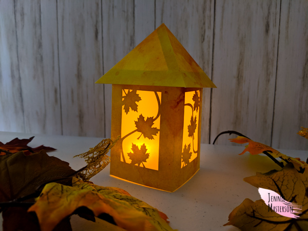 Finished fall lantern illuminated.