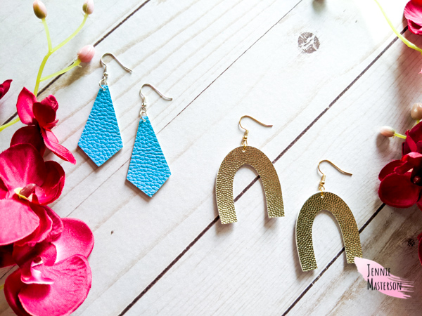 Two pairs of faux leather earrings, one gold, one blue.