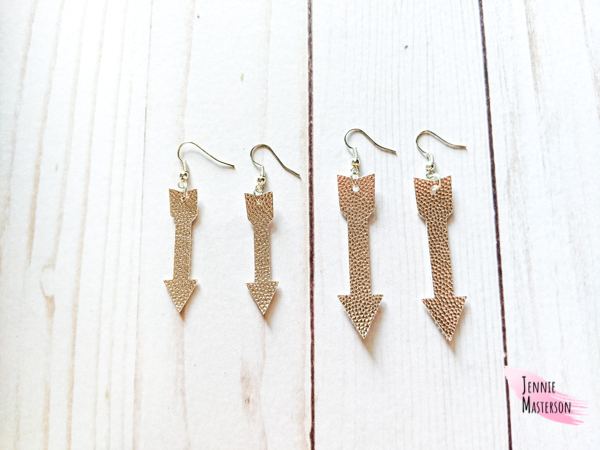 comparing the two sizes of faux leather earrings.