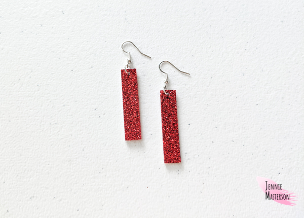 a Pair of glitter faux leather earrings.