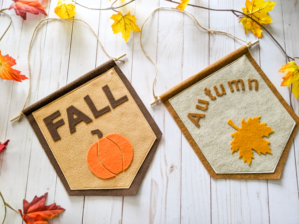 Two fall signs made from felt. One says "fall" the other says "Autumn".