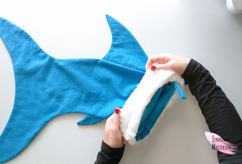 Folding the cuff piece down over the top of the shark body.