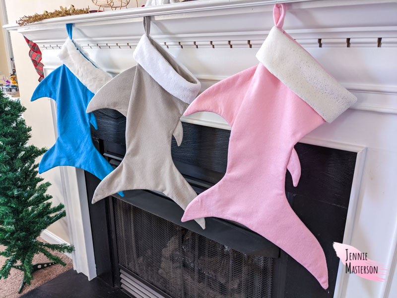 shark stockings hung on a mantel.