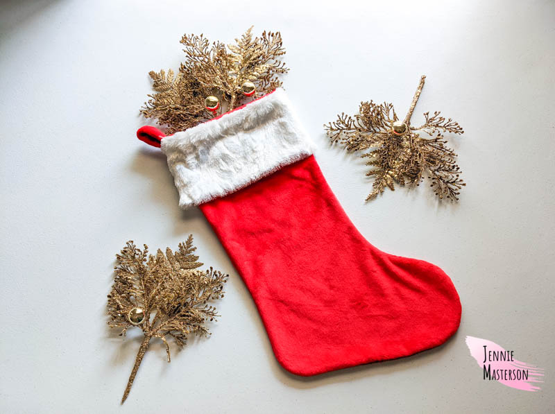 Traditional Christmas Stocking with gold leafing around it.