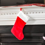 Christmas stocking hung over a fireplace mantle.