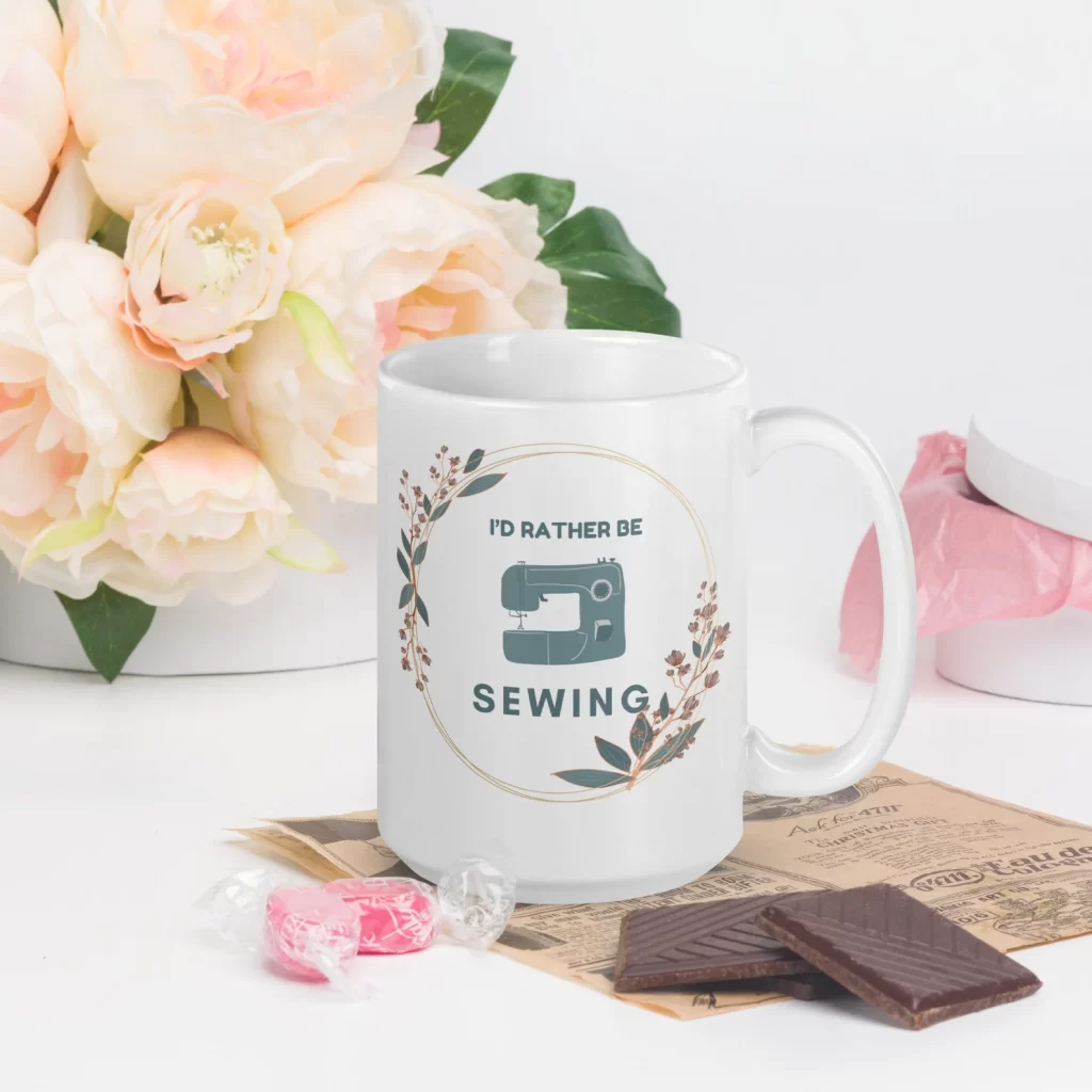 "I'd rather be sewing" coffee mug with a circle of flowers.