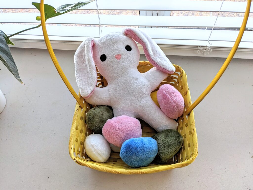 easter basket with bunny plushie and egg plushies.